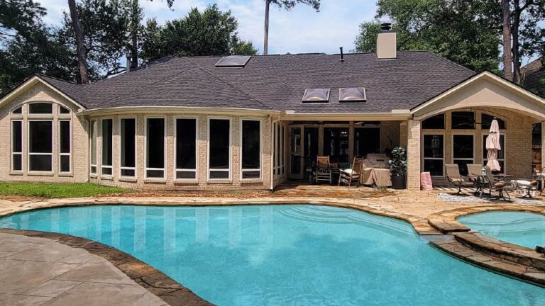 Backyard view with pool of house with windows